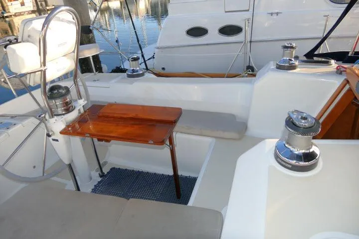 C Otter Yacht Photos Pics Cockpit of 2002 Tartan 3700 sailboat with wooden table and steering wheel.