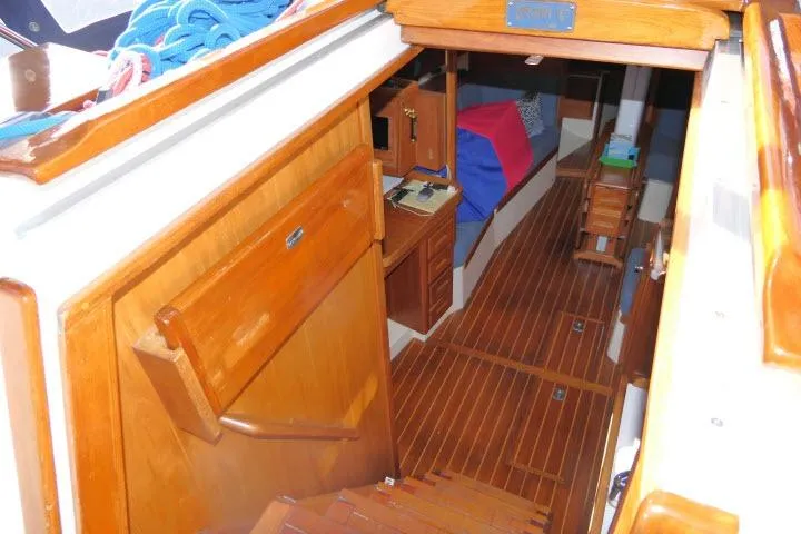 C Otter Yacht Photos Pics Interior view of 2002 Tartan 3700 sailboat, featuring wooden cabinetry and flooring.