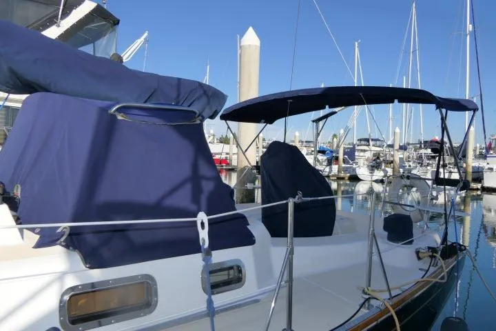 C Otter Yacht Photos Pics Sailboat Tartan 3700, 2002 model, docked at marina with blue covers and clear sky.