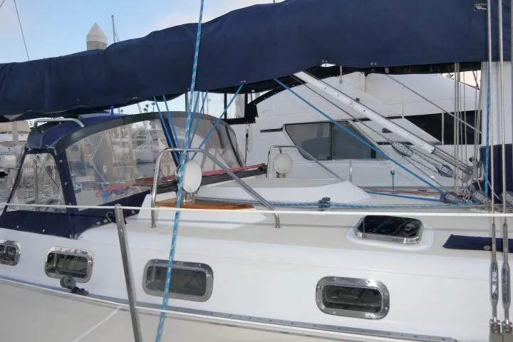 C Otter Yacht Photos Pics Sailboat docked at marina, Tartan 3700 model, 2002, with blue canopy and sleek design.