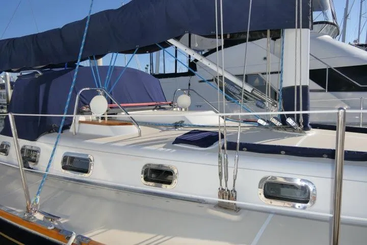 C Otter Yacht Photos Pics 2002 Tartan 3700 sailboat deck with blue covers and rigging in marina.