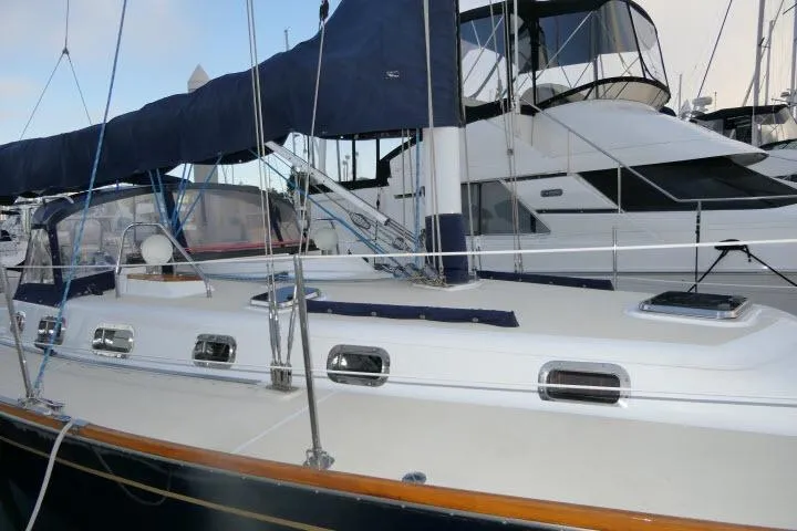 C Otter Yacht Photos Pics Sailboat Tartan 3700, 2002 model, docked at marina with blue canvas cover.