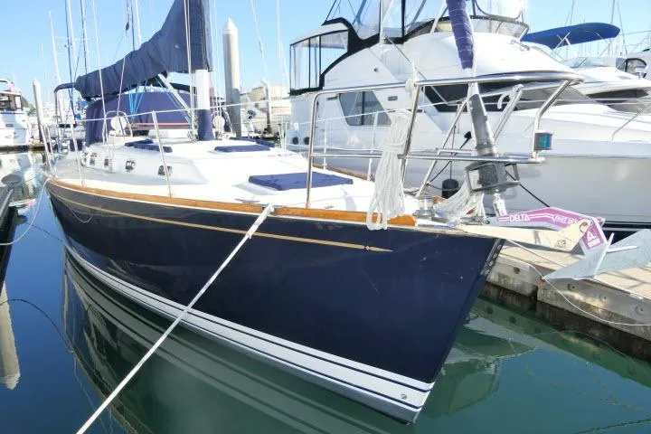 C Otter Yacht Photos Pics 2002 Tartan 3700 sailboat docked in marina, featuring sleek design and blue hull.