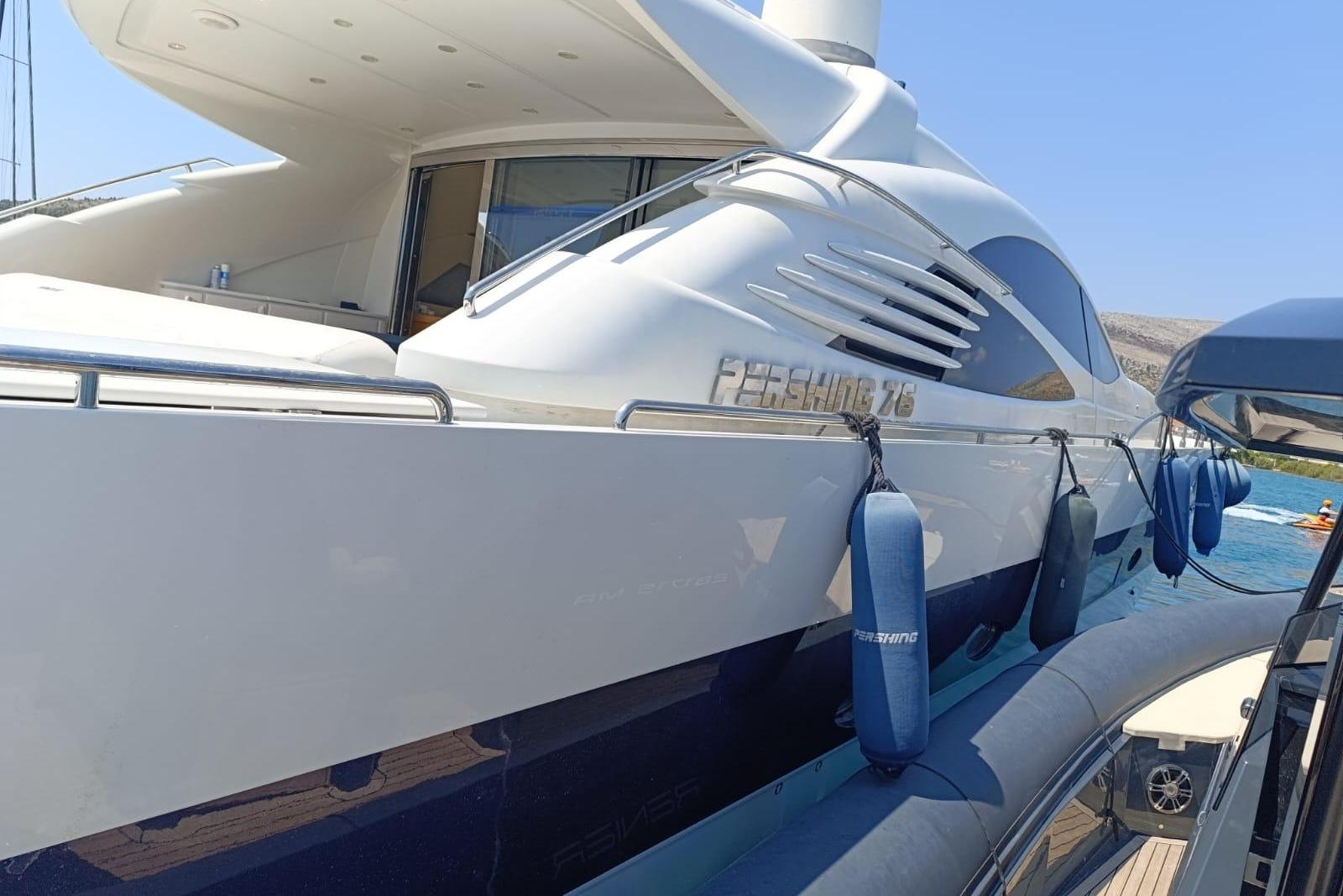 Luxury 2005 Pershing 76 yacht docked, featuring sleek design and modern amenities.