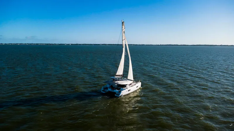 Blue Pearl Too Yacht Photos Pics Sailing Lagoon 42 catamaran on open water under clear blue sky, 2017 model.