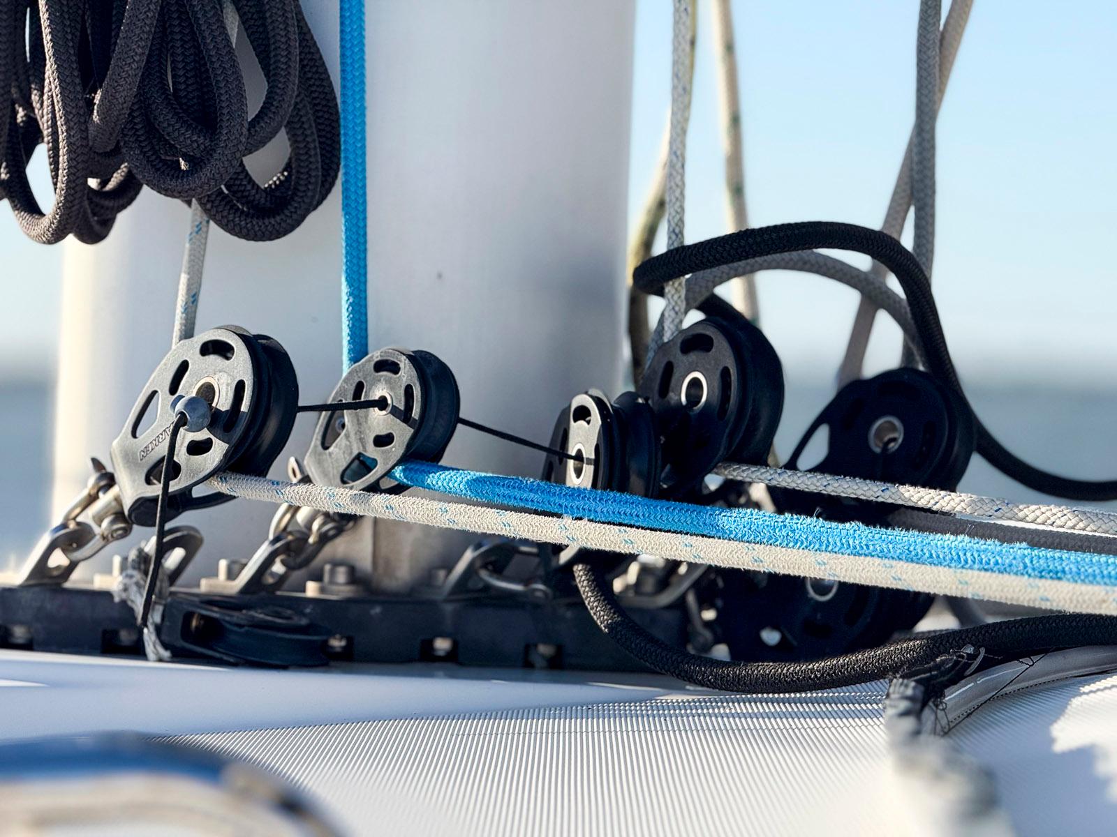 Close-up of rigging and pulleys on a 2017 Lagoon 42 catamaran sailboat.