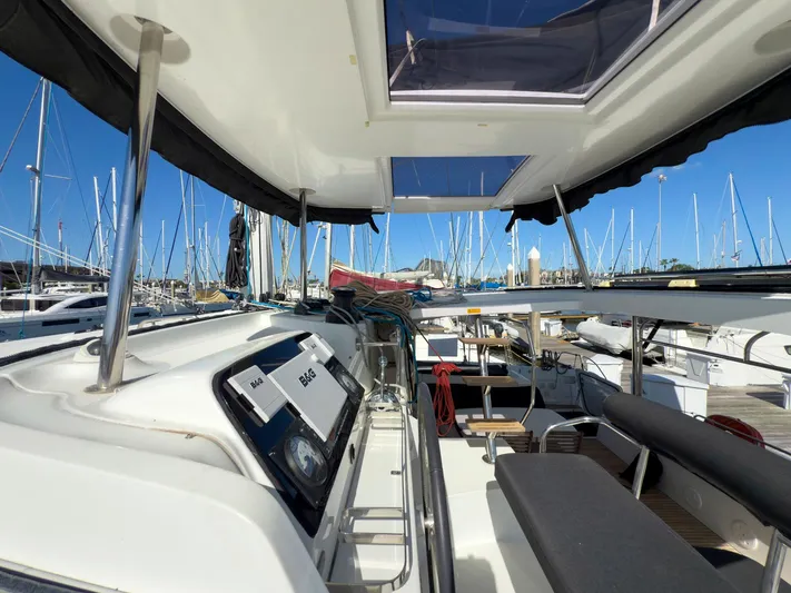 Blue Pearl Too Yacht Photos Pics 2017 Lagoon 42 catamaran interior view at marina, showcasing helm and seating area.