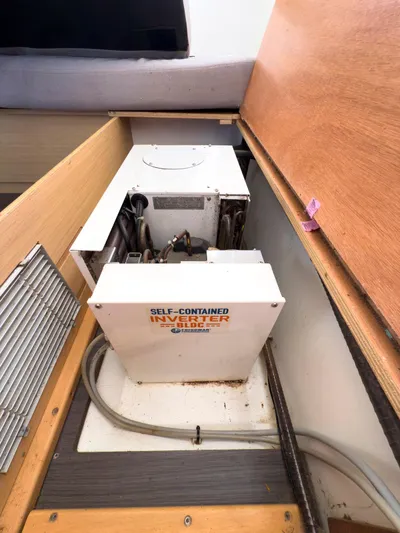 Blue Pearl Too Yacht Photos Pics Self-contained inverter inside a 2017 Lagoon 42 yacht, under a wooden compartment.