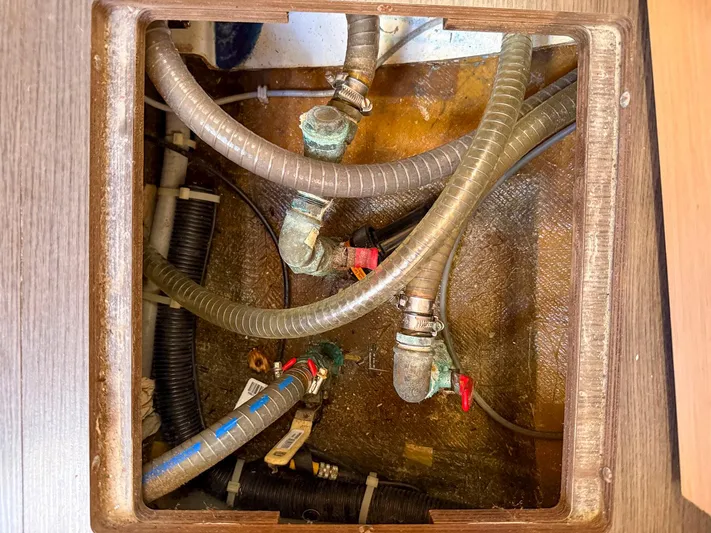 Blue Pearl Too Yacht Photos Pics Plumbing system inside a 2017 Lagoon 42 boat, featuring hoses and valves.