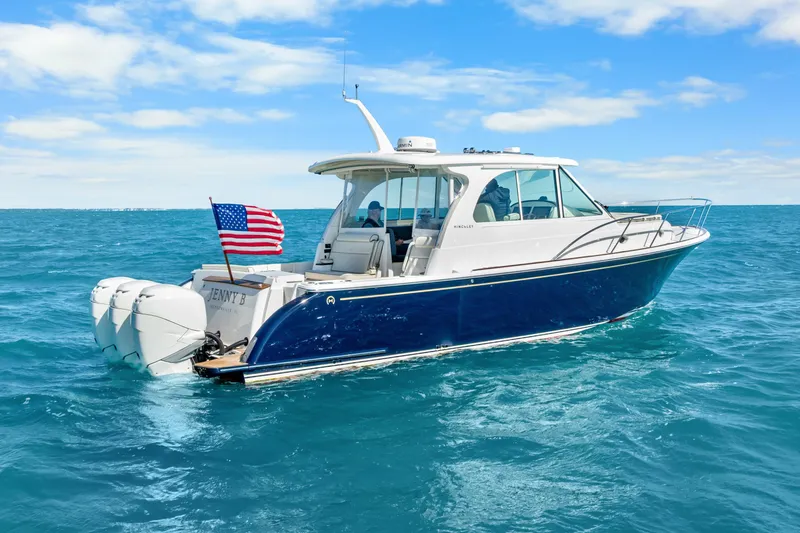 Jenny B Yacht Photos Pics 2021 Hinckley Sport Boat 40 X cruising on open water under a clear sky.