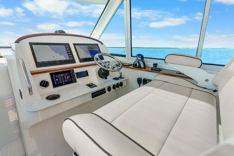 Jenny B Yacht Photos Pics Helm of 2021 Hinckley Sport Boat 40 X with navigation screens and steering wheel.