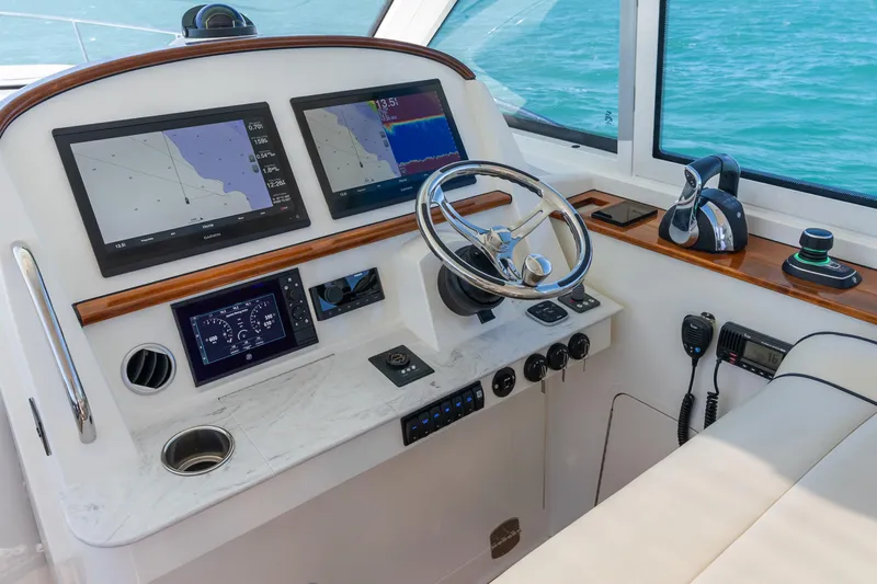Jenny B Yacht Photos Pics Helm of 2021 Hinckley Sport Boat 40 X with navigation screens and controls.