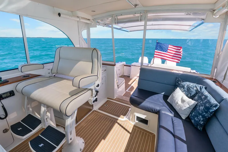 Jenny B Yacht Photos Pics Luxurious 2021 Hinckley Sport Boat 40 X interior with seating, ocean view, and American flag.
