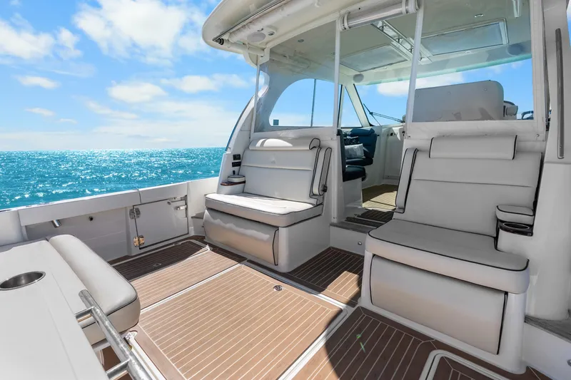 Jenny B Yacht Photos Pics 2021 Hinckley Sport Boat 40 X interior with luxurious seating, ocean view, and sunny skies.