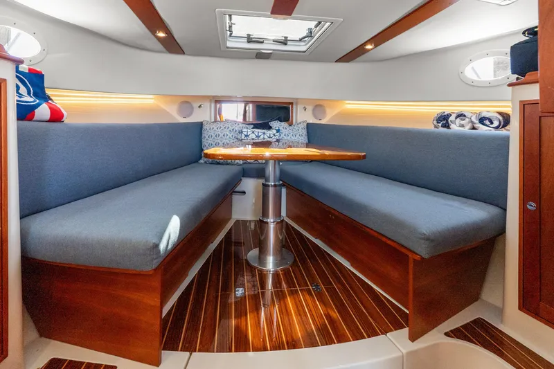 Jenny B Yacht Photos Pics Luxurious interior of 2021 Hinckley Sport Boat 40 X with elegant seating and wooden finishes.