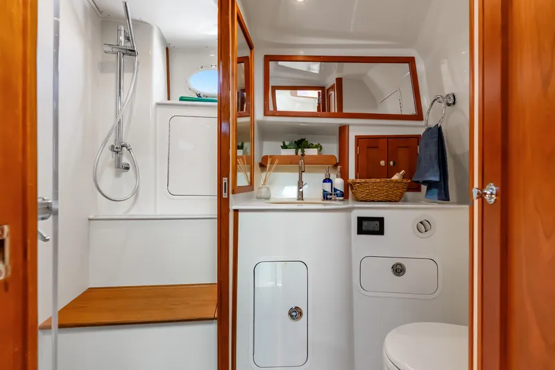 Jenny B Yacht Photos Pics Luxurious bathroom interior of 2021 Hinckley Sport Boat 40 X with wooden accents.