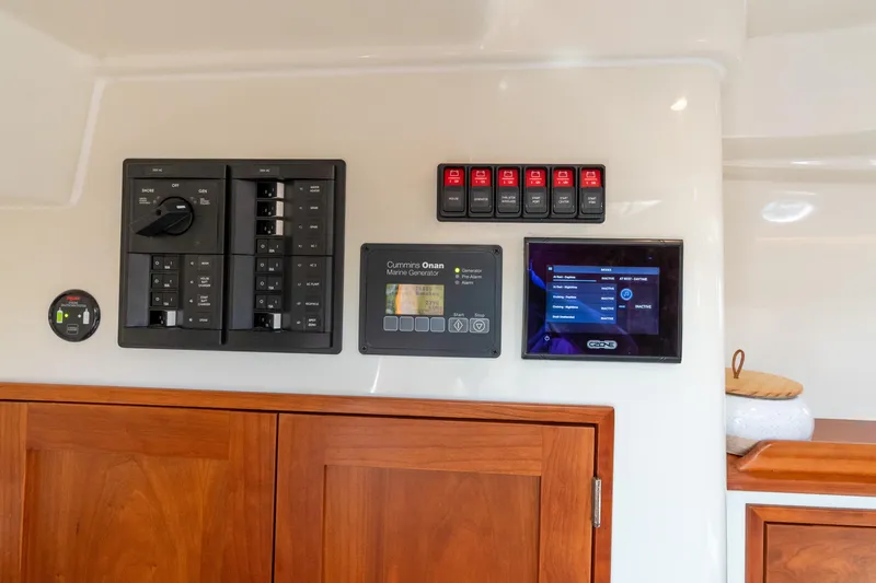 Jenny B Yacht Photos Pics Control panel of 2021 Hinckley Sport Boat 40 X with generator and display screen.