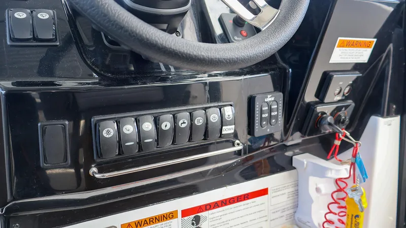 4803jg Yacht Photos Pics Control panel of 2021 Jeanneau NC 895 boat with switches and warning labels.