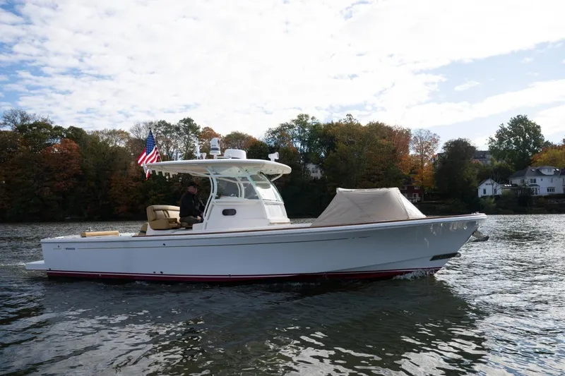 Minnow Yacht Photos Pics 2016 Hunt Yachts 32 Center Console cruising on a scenic river with autumn foliage.