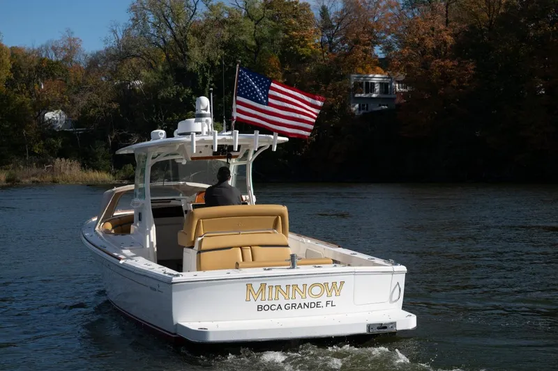 Minnow Yacht Photos Pics 2016 Hunt Yachts 32 Center Console boat with American flag on water.