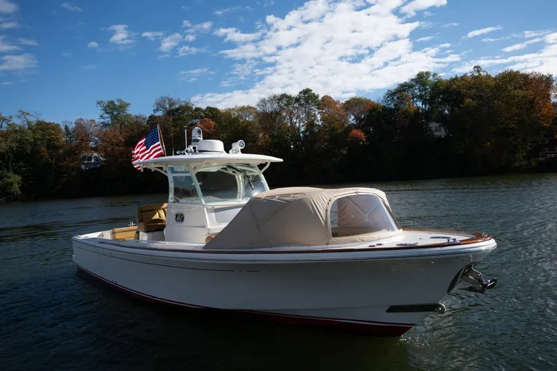 Minnow Yacht Photos Pics 2016 Hunt Yachts 32 Center Console on a scenic lake with American flag.