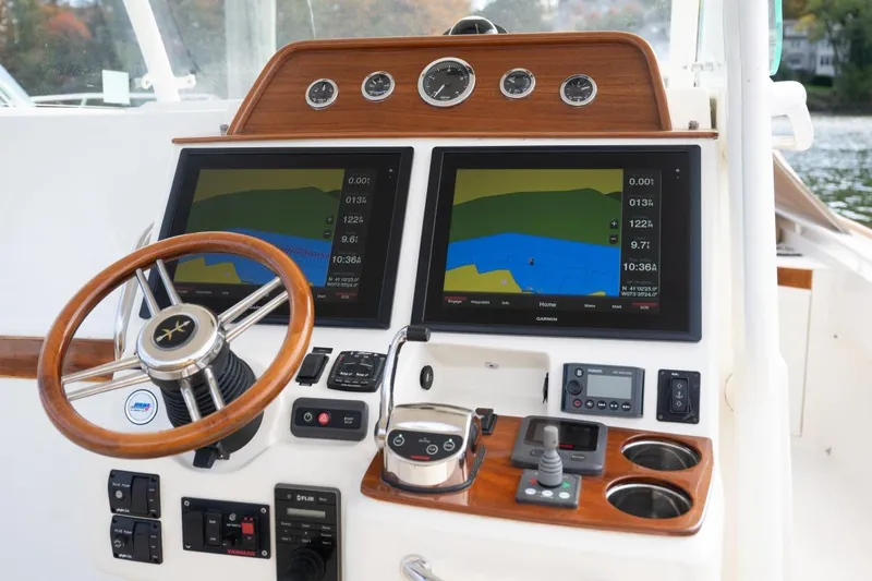 Minnow Yacht Photos Pics Helm of 2016 Hunt Yachts 32 Center Console with dual navigation screens and wooden accents.