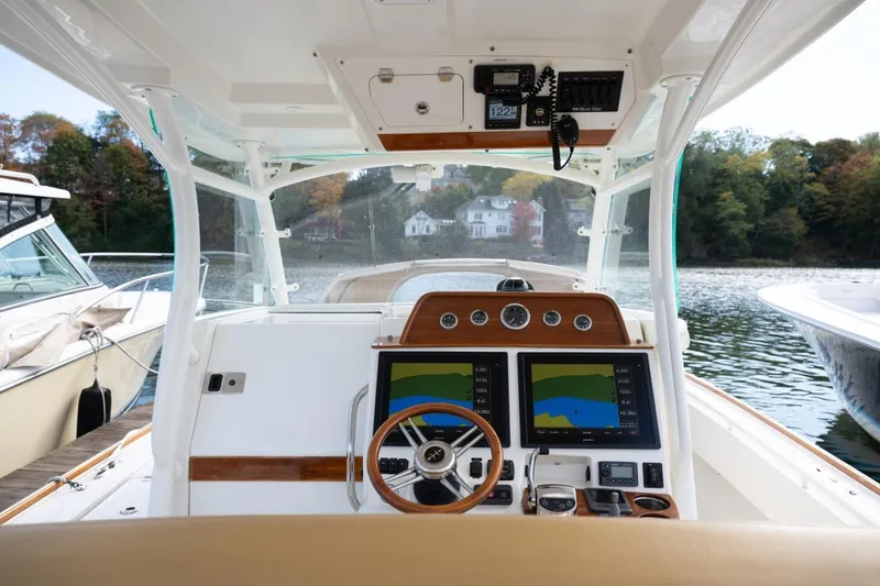 Minnow Yacht Photos Pics 2016 Hunt Yachts 32 Center Console helm with dual navigation screens and wooden accents.