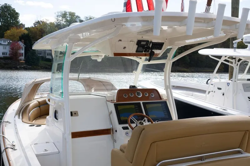 Minnow Yacht Photos Pics 2016 Hunt Yachts 32 Center Console boat with modern helm and seating on a serene waterway.