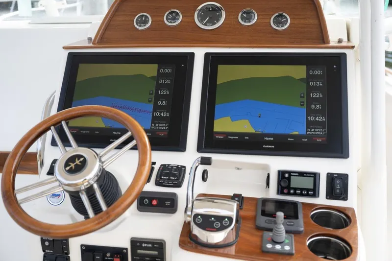 Minnow Yacht Photos Pics 2016 Hunt Yachts 32 Center Console dashboard with dual navigation screens and wooden steering wheel.