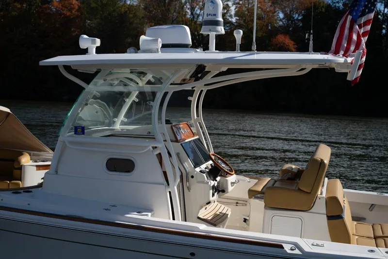 Minnow Yacht Photos Pics 2016 Hunt Yachts 32 Center Console boat on a calm lake.