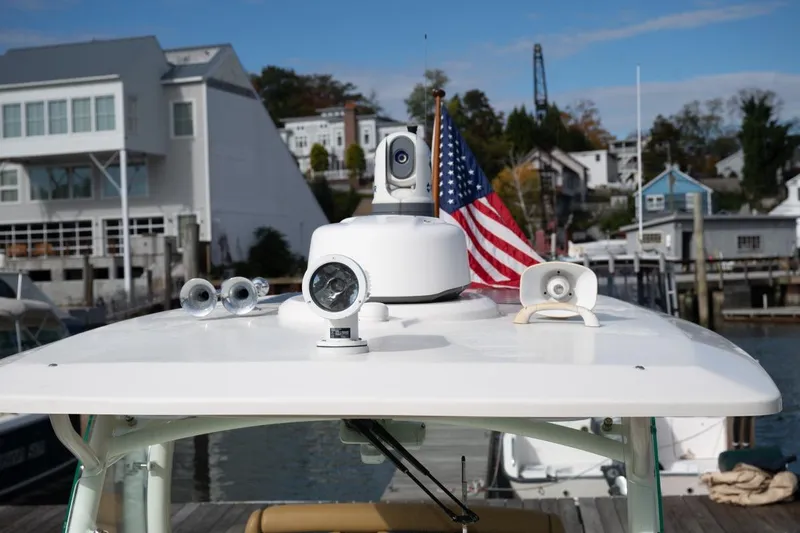 Minnow Yacht Photos Pics 2016 Hunt Yachts 32 Center Console with American flag, docked in a marina.
