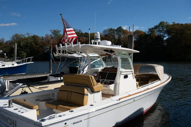 Minnow Yacht Photos Pics 2016 Hunt Yachts 32 Center Console docked, featuring sleek design and American flag.