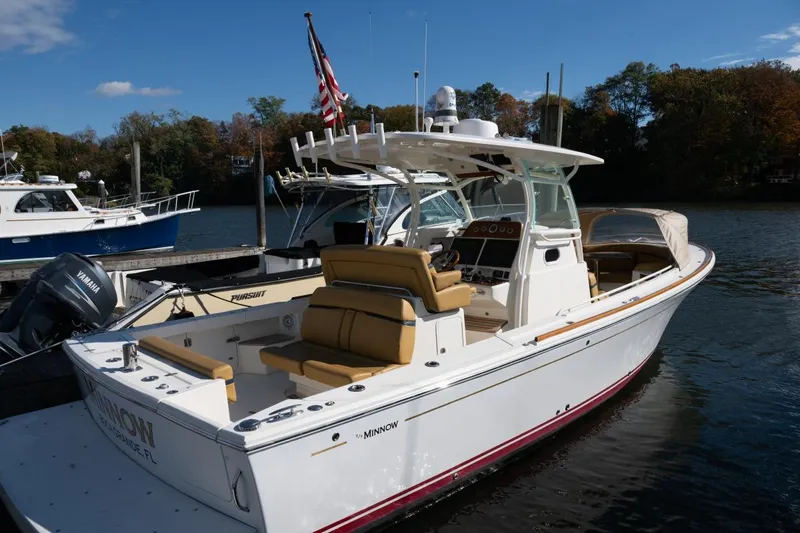 Minnow Yacht Photos Pics 2016 Hunt Yachts 32 Center Console docked, featuring sleek design and comfortable seating.