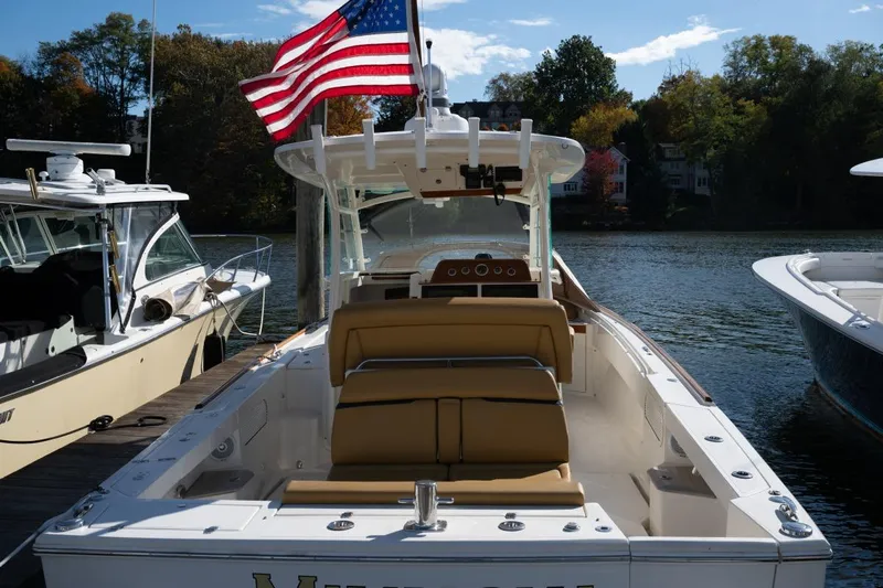 Minnow Yacht Photos Pics 2016 Hunt Yachts 32 Center Console docked, featuring tan seating and American flag.