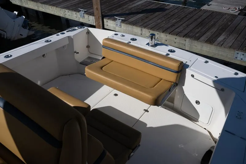 Minnow Yacht Photos Pics 2016 Hunt Yachts 32 Center Console with tan seating, docked at a wooden pier.