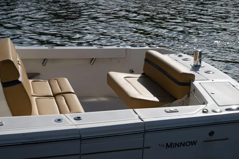 Minnow Yacht Photos Pics 2016 Hunt Yachts 32 Center Console with tan seating, docked on calm water.