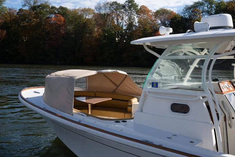 Minnow Yacht Photos Pics 2016 Hunt Yachts 32 Center Console on calm water with autumn trees in background.