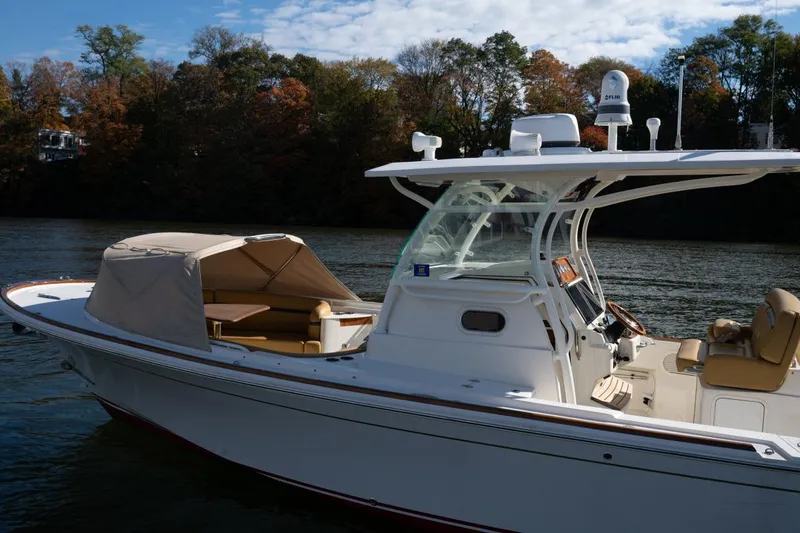 Minnow Yacht Photos Pics 2016 Hunt Yachts 32 Center Console on a serene river with autumn foliage.