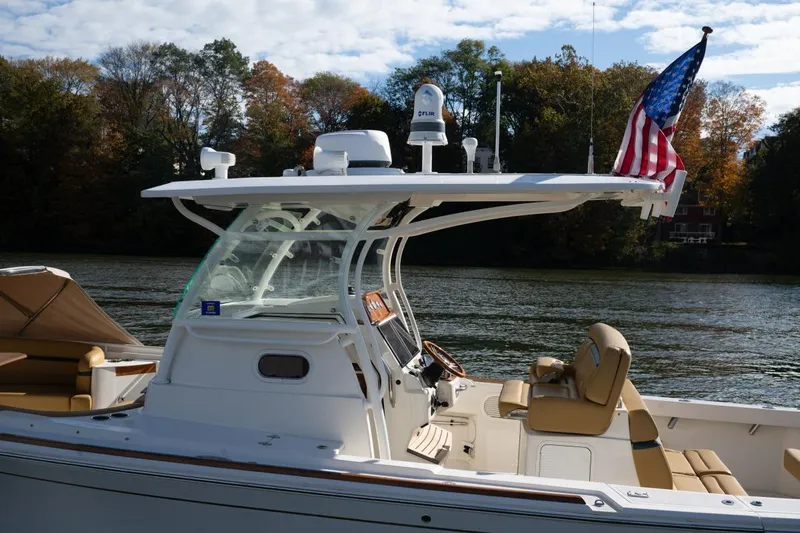 Minnow Yacht Photos Pics 2016 Hunt Yachts 32 Center Console boat with American flag on a calm river.