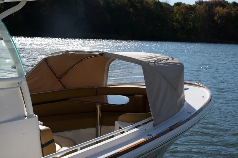 Minnow Yacht Photos Pics 2016 Hunt Yachts 32 Center Console on serene water, featuring a shaded seating area.
