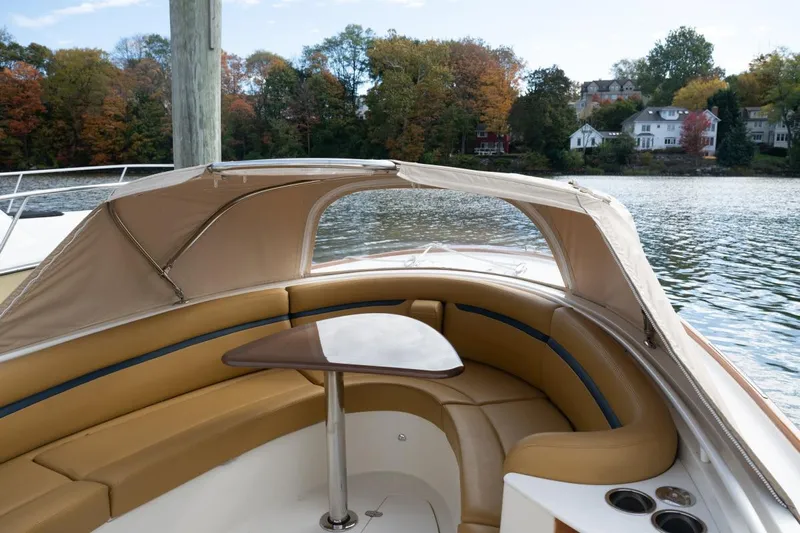 Minnow Yacht Photos Pics 2016 Hunt Yachts 32 Center Console with tan seating and canopy on a scenic lake.