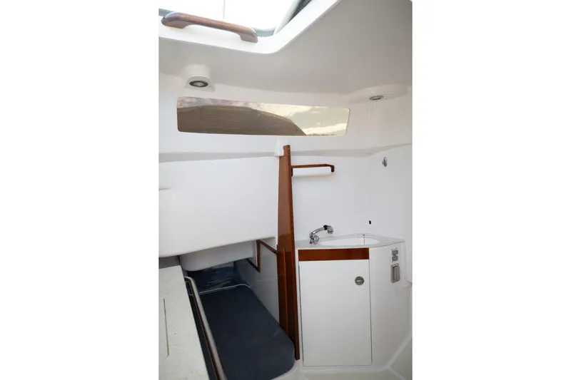 Minnow Yacht Photos Pics Interior of 2016 Hunt Yachts 32 Center Console, featuring a compact sink and wooden accents.