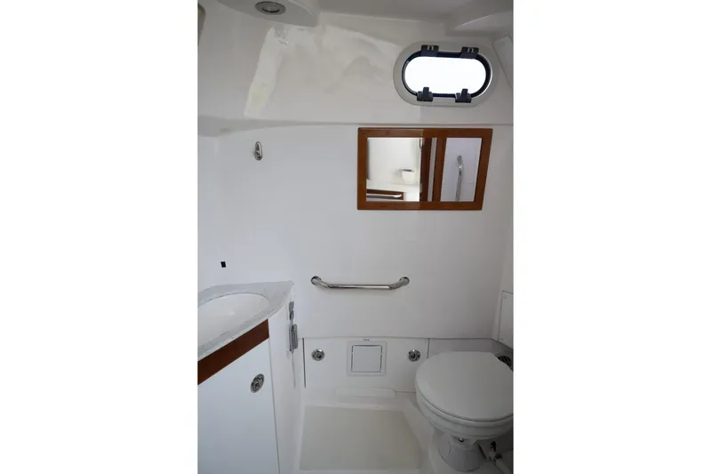 Minnow Yacht Photos Pics 2016 Hunt Yachts 32 Center Console bathroom interior with sink, toilet, and mirror.