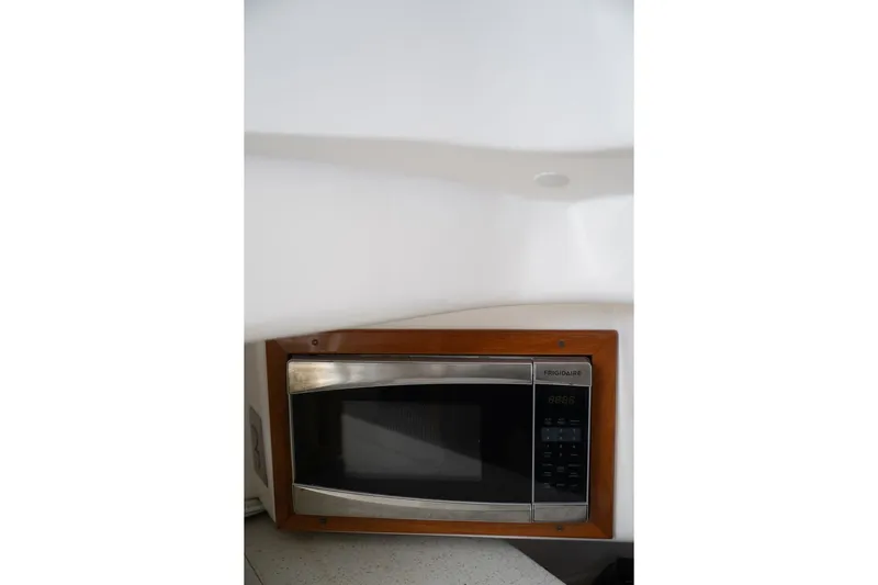 Minnow Yacht Photos Pics Microwave in 2016 Hunt Yachts 32 Center Console, featuring wood trim and modern design.