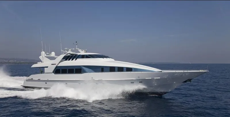 Moonraker Yacht Photos Pics Luxury 1992 Norship Motoryacht cruising on open sea under clear blue sky.