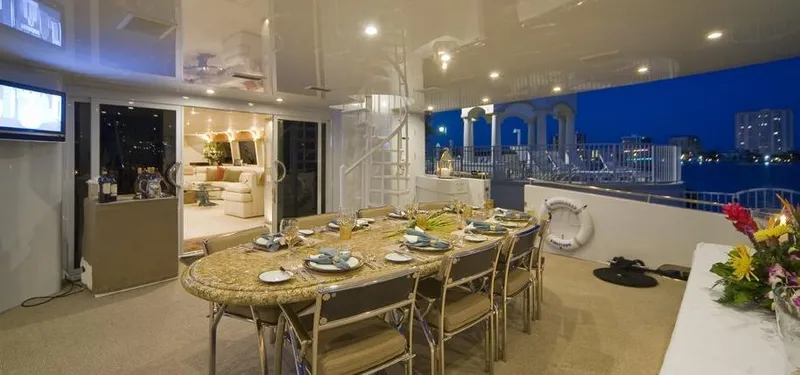 Moonraker Yacht Photos Pics Luxurious 1992 Norship Motoryacht dining area with elegant table setting and city view.