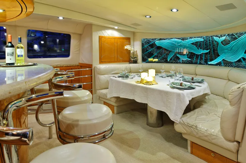 Moonraker Yacht Photos Pics Luxurious 1992 Norship Motoryacht interior with elegant dining area and bar seating.