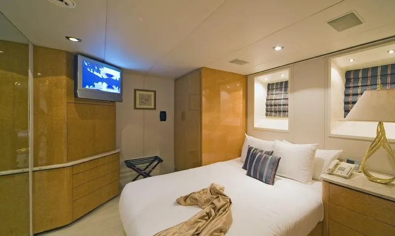 Moonraker Yacht Photos Pics Luxurious bedroom interior of a 1992 Norship Motoryacht with modern amenities and elegant decor.