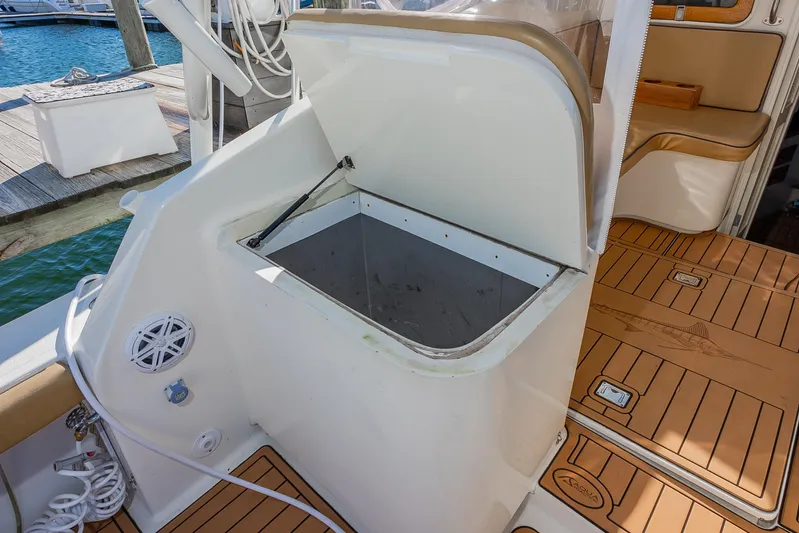 Moby Yacht Photos Pics Open storage compartment on 1987 Custom Carolina Island Boatworks 34 Express, docked by the water.