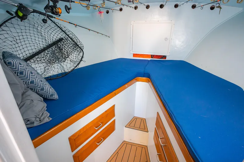 Moby Yacht Photos Pics Cozy cabin interior of 1987 Custom Carolina Island Boatworks 34 Express with blue cushions.